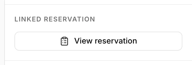 The Linked reservation section of the details panel, holding a single full-width outline button reading View reservation with a clipboard icon.