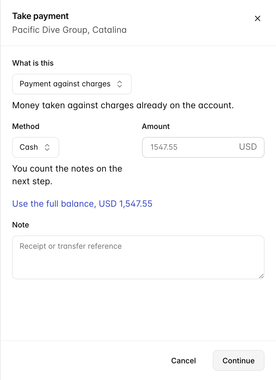 The Take payment panel for Pacific Dive Group, Catalina. A first field asks what the money is, offering Payment against charges or Deposit taken up front. Below it are a payment method, an amount field placeheld 1547.55 in USD, a link reading "Use the full balance, USD 1,547.55", and a note field placeheld "Receipt or transfer reference". The method is Cash, under it a hint reads "You count the notes on the next step", and the button at the foot reads Continue rather than Record payment.