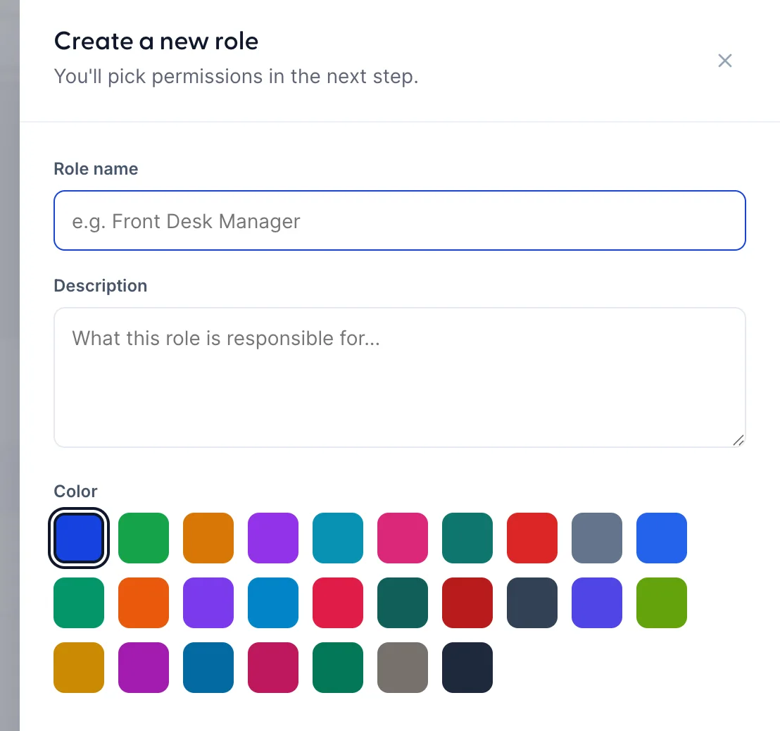 The top of a drawer headed Create a new role, subtitled "You'll pick permissions in the next step." It holds a Role name field with the placeholder "e.g. Front Desk Manager", a Description field with the placeholder "What this role is responsible for...", and a Color group of twenty-seven small colour swatches with the first one selected. Cancel and Create role buttons sit at the foot of the drawer, below the part shown here.